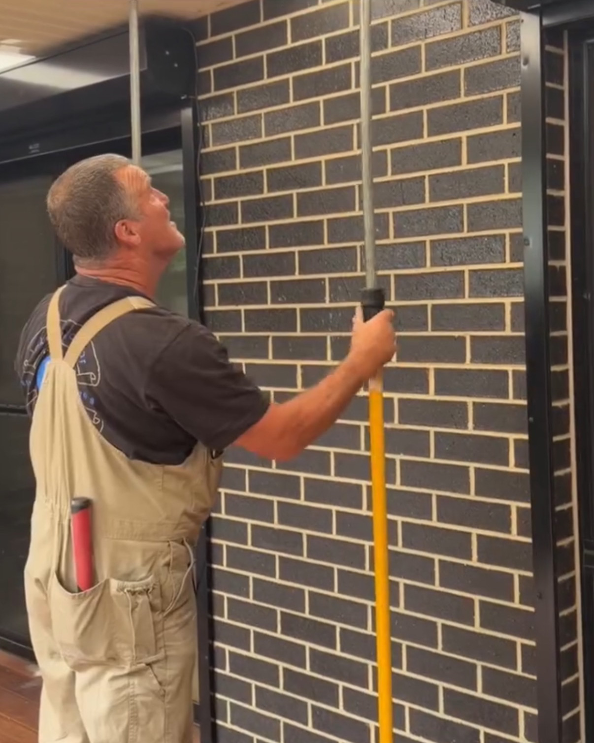 Chris Dawson installing a roller shutter