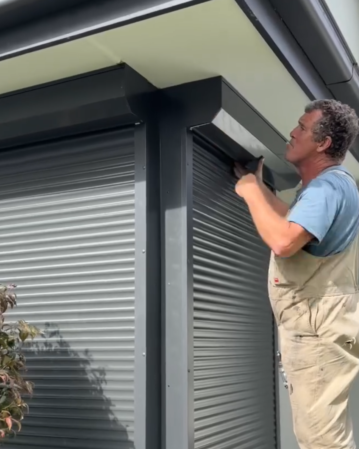 Chris installing a roller shutter on a residential home
